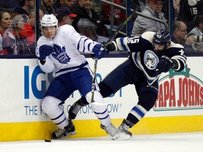 Toronto Maple Leafs forward Ben Smith works against Columbus Blue Jackets forward Lukas Sedlak during an NHL game on Feb. 15, 2017. (AP Photo/Paul Vernon)