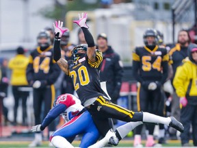 Hamilton Tiger-Cats' Emanuel Davis and Montreal Alouettes' Duron Carter during a CFL game at Alumni Stadium on Oct. 26, 2013. (Ernest Doroszuk/Toronto Sun)