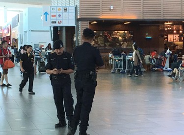 Police officers man at Kuala Lumpur International Airport where North Korean Kim Jong Nam was reportedly assassinated in Kuala Lumpur, Malaysia, Thursday, Feb. 16, 2017. Malaysian police arrested a second woman Thursday in the death of Kim, the half brother of North Korea's leader who was reportedly poisoned this week by two female assassins as he waited for a flight in Malaysia. (AP Photo/Margie Mason) ORG XMIT: TKTT101