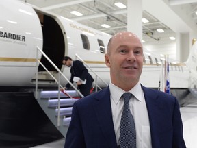 Bombardier CEO Alain Bellemare poses in front of a model of a Global 7000 jet before a press conference in Montreal on Tuesday, February 7, 2017. (THE CANADIAN PRESS/Paul Chiasson)