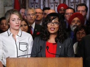 Liberal MP Iqra Khalid makes an announcement about an anti-Islamophobia motion on Parliament Hill while Minister of Canadian Heritage Melanie Joly looks on in Ottawa on Wednesday, Feb. 15, 2017. THE CANADIAN PRESS/Patrick Doyle