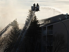 Edmonton Fire Rescue Services firefighters battle a blaze at Westridge Estates in Edmonton on Thursday, February 16, 2017. Ian Kucerak / Postmedia