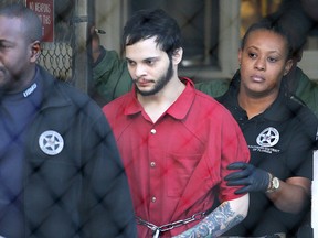 In this Jan. 30, 2017, file photo, Esteban Santiago, centre, is led from the Broward County jail for an arraignment in federal court in Fort Lauderdale, Fla.  (AP Photo/Lynne Sladky, File)