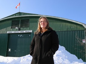 Tim Miller/The Intelligencer
Nancy Bruinsma stands in front of one of two First World War era hangars at the Napanee fairgrounds which were originally used to house biplanes at Desertonto's Camp Rathbun on Thursday in Napanee. Bruinsma is holding a heritage event on June 10 in Deseronto to help raise awareness of some of the region's history.