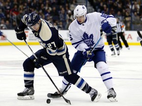 Columbus Blue Jackets defenceman Ryan Murray works for the puck against Toronto Maple Leafs forward Mitch Marner during an NHL game on Feb. 15, 2017. (AP Photo/Paul Vernon)