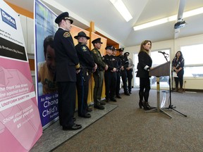 Psychologist Kelli McMillan (right) speaks during a press conference to announce a new anti-bullying pin for law enforcement and first responders to wear on Pink Shirt Day in Edmonton on Thursday, February 16, 2017. Ian Kucerak / Postmedia
