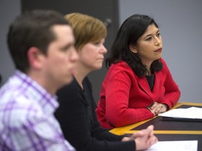 London lawyer Susan Toth, right, a member of a community group, listens at a police services meeting with group members Joe Antone and Shawna Lewkowitz on Thursday. (MIKE HENSEN, The London Free Press)