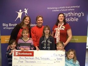 David Abrams of Scotiabank Tillsonburg (centre) presents a cheque for $5,000 to Deb Landon, Executive Director and Heather Brekelmans, Resource Coordinator, Big Brothers Big Sisters of Ingersoll, Tillsonburg and area with help from some young friends. (CONTRIBUTED PHOTO)