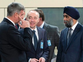 Canadian Defense Minister Harjit Singh Sajjan, right, speaks with Croatian Defense Minister Damir Krsticevic, center, and Bulgarian Defense Minister Stefan Yanev, left, during a meeting of the North Atlantic Council at NATO headquarters in Brussels on Thursday, Feb. 16, 2017. U.S. Defense Secretary Jim Mattis on Wednesday told NATO ministers that the alliance is "a fundamental bedrock for the United States" while at the same time demanding an increased financial commitment from the 27 other alliance members.  (THE CANADIAN PRESS/AP-Virginia Mayo )