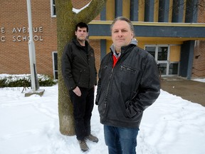 Activists Scott Maclean, left, and Peter Strack in front of the old Lorne Avenue public school. City staff has recommended it be torn down. (MORRIS LAMONT, The London Free Press)