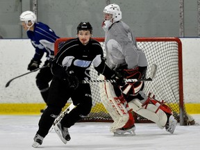 London Knights defence man Victor Mete crosses in front of Jordan Kooy during practice at the Western Fair on Tuesday February 14, 2017. (MORRIS LAMONT, The London Free Press)