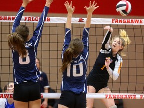 Oakridge?s Hannah Petcoff pounds a ball down the line away from the combined blocks of Valerie Bousygine, left, and Shayla Martin-Fenn of Lucas during their TVRA Central AAA senior girls volleyball final at Fanshawe College in London Thursday. The Oaks won 3-1, but since both advance to WOSSAA regional playdowns next week, there?s a good chance the two powerhouse teams will meet again. (MIKE HENSEN, The London Free Press)