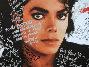 A poster of Michael Jackson is covered with messages from fans at a one-day tribute to the 'King of Pop' which included outdoor screenings of 'The Wiz' and 'Thriller' at Universal CityWalk in Universal City, California on July 9, 2009.  (Photo credit should read ROBYN BECK/AFP/Getty Images)