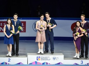 Winners Tessa Virtue and Scott Moir of Canada (C), second-placed Maia Shibutani and Alex Shibutani of the US (L) and third-placed Madison Chock and Evan Bates of the US (R) pose during the awards ceremony after the ice dance free dance event at the ISU Four Continents Figure Skating Championships at the Gangneung Ice Arena in Gangneung on February 17, 2017. (Getty Image)