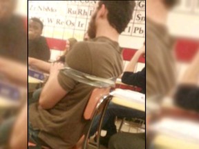 A photo showing a student at Bangor High School (Mich.) being taped to his chair. (WWMT screen grab)