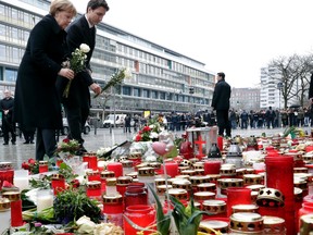 German Chancellor Angela Merkel (left) and Prime Minister Justin Trudeau (right) lay down flowers in Berlin on Friday, Feb. 17, 2017, to commemorate the victims of a terror attack on the Breitscheidplatz in December 2016. (Michael Sohn/AP Photo)
