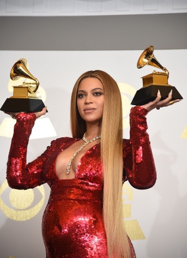 Singer Beyonce poses with her Grammy trophies in the press room during the 59th Annual Grammy music Awards on February 12, 2017, in Los Angeles, California.  / AFP PHOTO / Robyn BECKROBYN BECK/AFP/Getty Images