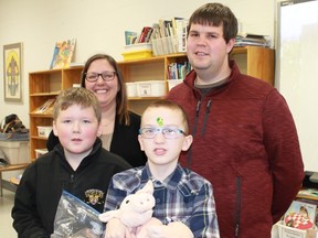 Grade 5 Queen Elizabeth II Public School students Troy Hanna and Wyatt Steinburg stand with local farmers Blair Williamson and Brooke Leystra following a presentation about agriculture at the school.
CARL HNATYSHYN/SARNIA THIS WEEK