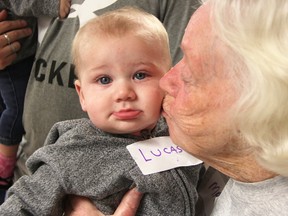 Mary Ross gives Lucas Baril, six months, a kiss at a Storytime playgroup event at Vision Nursing Home Friday. The group is designed to bring seniors and youngsters together. (Tyler Kula/Sarnia Observer)