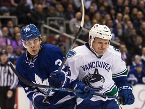 Toronto Maple Leafs centre Auston Matthews (34) collides with Vancouver Canucks winger Derek Dorsett Saturday November 5, 2016. (Craig Robertson/Toronto Sun)