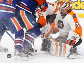 Philadelphia Flyers goalie Michal Neuvirth (30) looks for the rebound against the Edmonton Oilers during second period NHL action in Edmonton, Alta., on Thursday February 16, 2017.