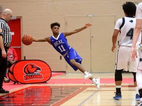 Jahleel Hilts, one of four Grade 10 starters for Beal, lunges to keep a ball inbounds during the TVRA Central AAA senior boys basketball final against the Laurier Rams at Fanshawe College on Friday. The Raiders won 56-44. (MIKE HENSEN, The London Free Press)