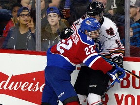 Oilkings rookie Matthew Robertson knocks Hitmen Beck Malenstyn off the puck as the Calgary Hitmen took on the Edmonton Oil Kings at the Scotiabank Saddledome in Calgary, Alta., on February 17, 2017. The Oil Kings lost 2-1 in overtime.