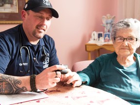 Garry Lauzon, a community paramedic, checks 91-year-old Maria’s oxygen levels. She still lives in her own home and wants to stay there. Mary Katherine Keown/The Sudbury Star