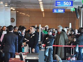 Passengers of a Turkish Airlines flight to Toronto wait at the boarding gate in Istanbul's Ataturk international airport, Saturday, Feb. 18, 2017. (DHA-Depo Photos via AP)