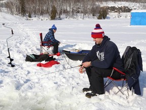 Chad Brousseau, left, and Tyler Gliebe enjoy a day of ice fishing on Simon Lake in Naughton, Ont. on Saturday February 18, 2017. John Lappa/Sudbury Star/Postmedia Network