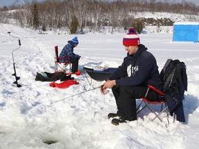 Chad Brousseau, left, and Tyler Gliebe enjoy a day of ice fishing on Simon Lake in Naughton, Ont. on Saturday February 18, 2017. Families and fishing enthusiasts across Ontario were able to fish license-free from Feb. 18-20, in celebration of Family Day on Feb. 20. John Lappa/Sudbury Star/Postmedia Network