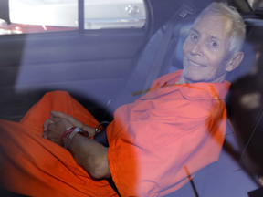 In March 17, 2015, file photo, New York real estate heir Robert Durst smiles as he is transported from Orleans Parish Criminal District Court to the Orleans Parish Prison after his arraignment on murder charges in New Orleans. (AP Photo/Gerald Herbert)