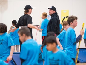 Garth Brooks and former Edmonton Oiler Ryan Smyth, joined and 60 boys and girls ages 9-13 from the Boys & Girls Clubs of Edmonton & Big Brothers Big Sisters of Edmonton on  Feb. 18, 2017, at a West Edmonton School. The famous duo captained relay race teams with the kids.  Photo by Shaughn Butts / Postmedia