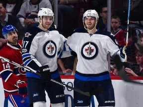 Joel Armia of the Winnipeg Jets celebrates his goal with teammate Adam Lowry during a game against the Montreal Canadiens at the Bell Centre on February 18, 2017 in Montreal. (Minas Panagiotakis/Getty Images)