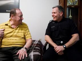 Ernie Saruk, 78, left, shares a story with Cst. Brian Meyer at his home in Edmonton, Alta., on Saturday, Feb. 18, 2017. The 51-year-old police officer, who drove trucks for a living before law enforcement, went above and beyond the call of duty when he went to check on Saruk, and visited him in the hospital. (Codie McLachlan/Postmedia)