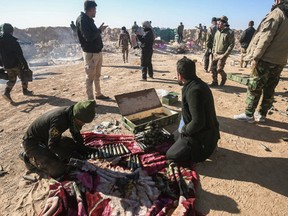 Fighters of the Hashed al-Shaabi (Popular Mobilisation) paramilitaries prepare ammunition at a defensive position near the frontline village of Ayn al-Hisan, on the outskirts of Tal Afar west of Mosul, where Iraqi forces are preparing for the offensive retake the western side of Mosul from Islamic State (IS) group fighters, on February 18, 2017. (AFP PHOTO)