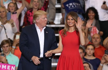 U.S. President Donald Trump and Melania Trump stand together during a campaign rally at the AeroMod International hangar at Orlando Melbourne International Airport on Feb. 18, 2017 in Melbourne, Fla. (Joe Raedle/Getty Images)
