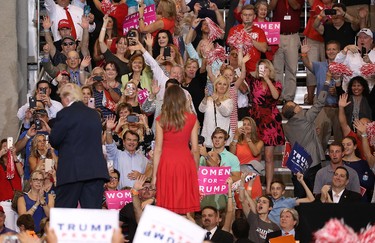 People react as they look on at U.S. President Donald Trump and Melania Trump during a campaign rally at the AeroMod International hangar at Orlando Melbourne International Airport on Feb. 18, 2017 in Melbourne, Fla. (Joe Raedle/Getty Images)