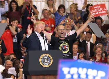 U.S. President Donald Trump introduces Gene Huber on stage to speak during a campaign rally at the AeroMod International hangar at Orlando Melbourne International Airport on Feb. 18, 2017 in Melbourne, Fla. (Joe Raedle/Getty Images)