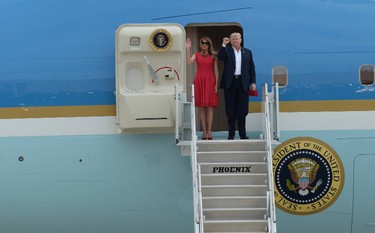 U.S. President Donald Trump and first lady Melania Trump wave from the top of the steps of Air Force One after they arrive to speak at his "Make America Great Again Rally" at Orlando-Melbourne International Airport in Melbourne, Fla., Saturday, Feb. 18, 2017. (AP Photo/Susan Walsh)