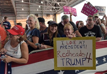 People wait to hear U.S. President Donald Trump speak at his "Make America Great Again Rally" at Orlando-Melbourne International Airport in Melbourne, Fla., Saturday, Feb. 18, 2017. (AP Photo/Susan Walsh)