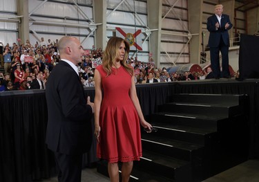 First lady Melania Trump walks off of the stage as U.S. President Donald Trump, right, prepares to speak at his "Make America Great Again Rally" at Orlando-Melbourne International Airport in Melbourne, Fla., Saturday, Feb. 18, 2017.  (AP Photo/Susan Walsh)