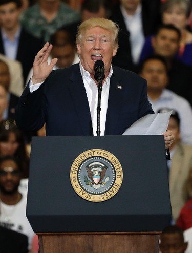 U.S. President Donald Trump gestures as he stops reading from a piece of paper during a campaign rally Saturday, Feb. 18, 2017, in Melbourne, Fla. (AP Photo/Chris O'Meara)