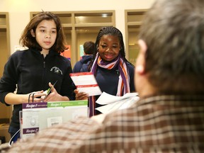 Dan Xilon, right, executive director of the Sudbury Food Bank, speaks to Ecole secondaire du Sacre-Coeur students Christine Vana, 14, left, and Christelle Mahie, 15, at Benefair 2016 at the Holiday Inn in Sudbury, Ont. on Wednesday February 24, 2016. The trade show-style fair was held for secondary school students from both local French-language school boards to promote volunteerism in the Greater Sudbury area. The event featured workshops and a number of community organizations promoting their services at the fair. John Lappa/Sudbury Star/Postmedia Network