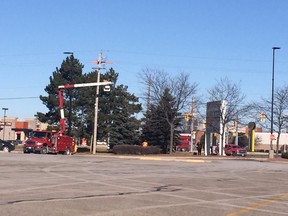 Bluewater Power crews work at the intersection of Exmouth Street and Barclay Drive Sunday. Sarnia police are searching for a driver involved in a single-vehicle crash at this intersection early Sunday morning. Police say the crash resulted in power and traffic signals being down in this area. PHOTO COURTESY OF BLUEWATER POWER