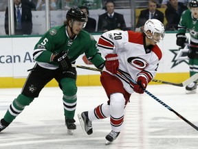 Carolina Hurricanes' Sebastian Aho (20) skates the puck up ice as Dallas Stars' Jamie Oleksiak (5) chases during the first period of an NHL hockey game, Saturday, Feb. 11, 2017, in Dallas. (AP Photo/Mike Stone)