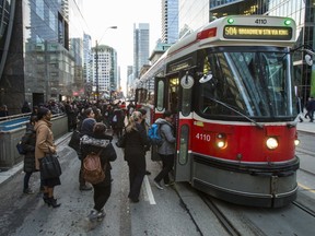 Transit riders board a streetcar along King St. W., at University Ave. (ERNEST DOROSZUK, Toronto Sun)