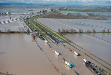 In this view looking north, flood water crosses over Interstate 5 at Williams backing up traffic in both north and southbound lanes for hours on Saturday, Feb. 18, 2017 in Williams, Calif. (Randy Pench/The Sacramento Bee via AP)