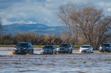 A flooded Interstate 5 snarled traffic for miles on Saturday, Feb. 18, 2017, in Maxwell, Calif.  (Andrew Seng/The Sacramento Bee via AP)