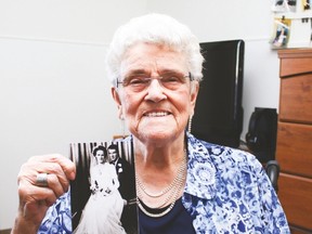 Audrey Lucas, 89, holds her wedding photo of her and her husband Gordon, taken in 1946.